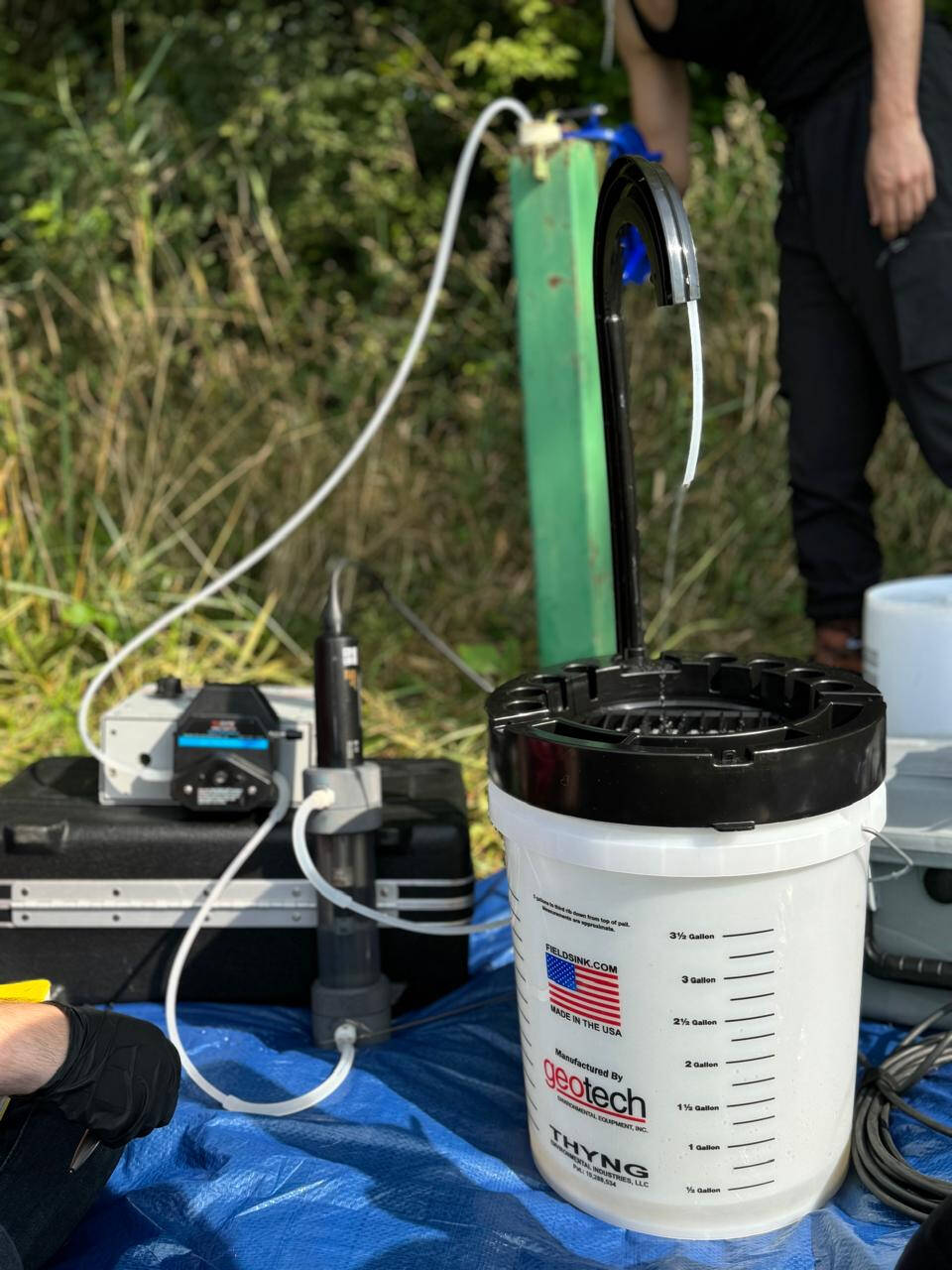 groundwater pump and bucket next to a well